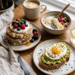 High Protein Breakfast spread with cottage cheese pancakes, yogurt, berries and avocado egg toast