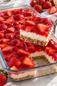 Finished strawberry pretzel salad with pretzel crust, cream filling, and strawberries