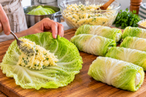 Filling Cheesy Potato Stuffed Cabbage Rolls before baking
