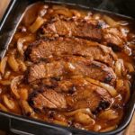 Slow Cooker Salisbury Steak with tender beef patties, sliced onions, and rich brown gravy.