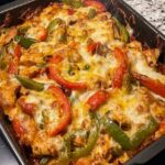 Chicken Fajita Casserole with seasoned chicken, red and green peppers, onions, and melted cheese.