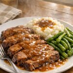Slow cooker pot roast with rich gravy, mashed potatoes, and green beans